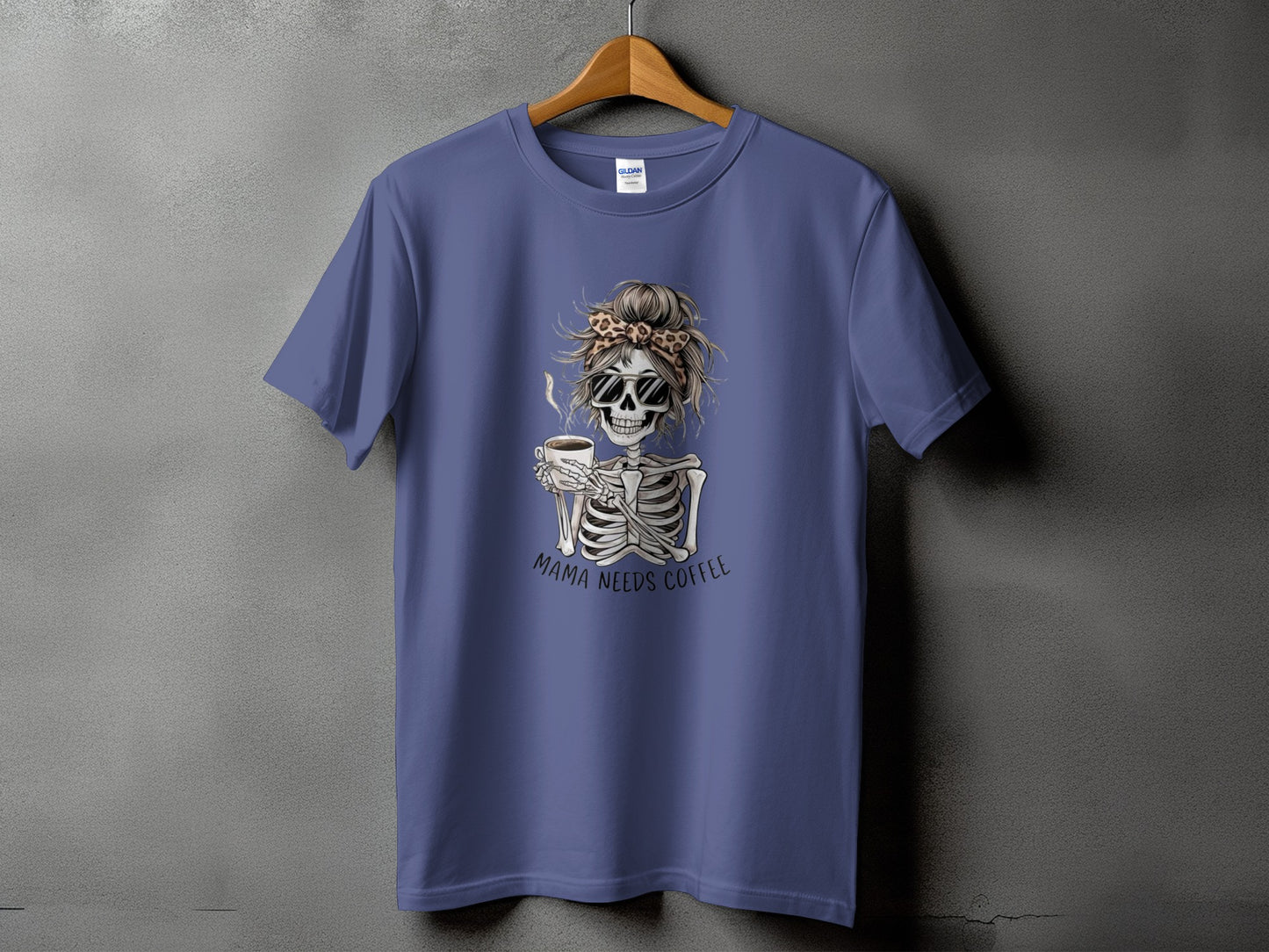 Skeleton with sunglasses and messy bun holding coffee cup, text "Mama Needs Coffee".