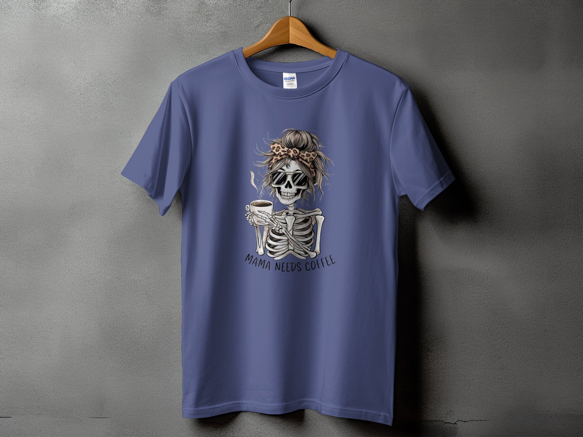 Skeleton with sunglasses and messy bun holding coffee cup, text "Mama Needs Coffee".