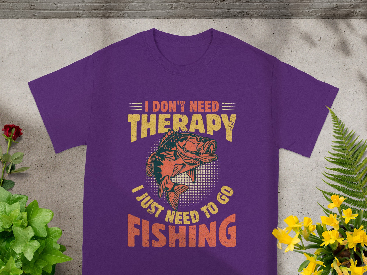 Purple t-shirt with "I Don't Need Therapy, I Just Need To Go Fishing" text and fish graphic.