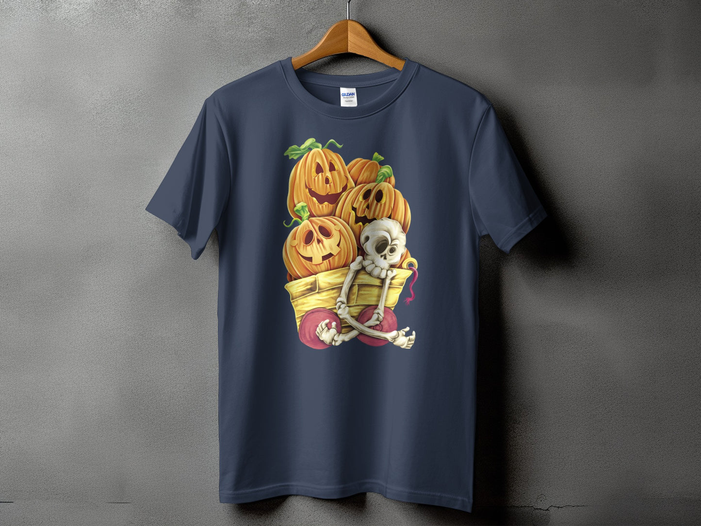 Dark blue t-shirt with Halloween pumpkins and a skeleton in a wagon graphic.