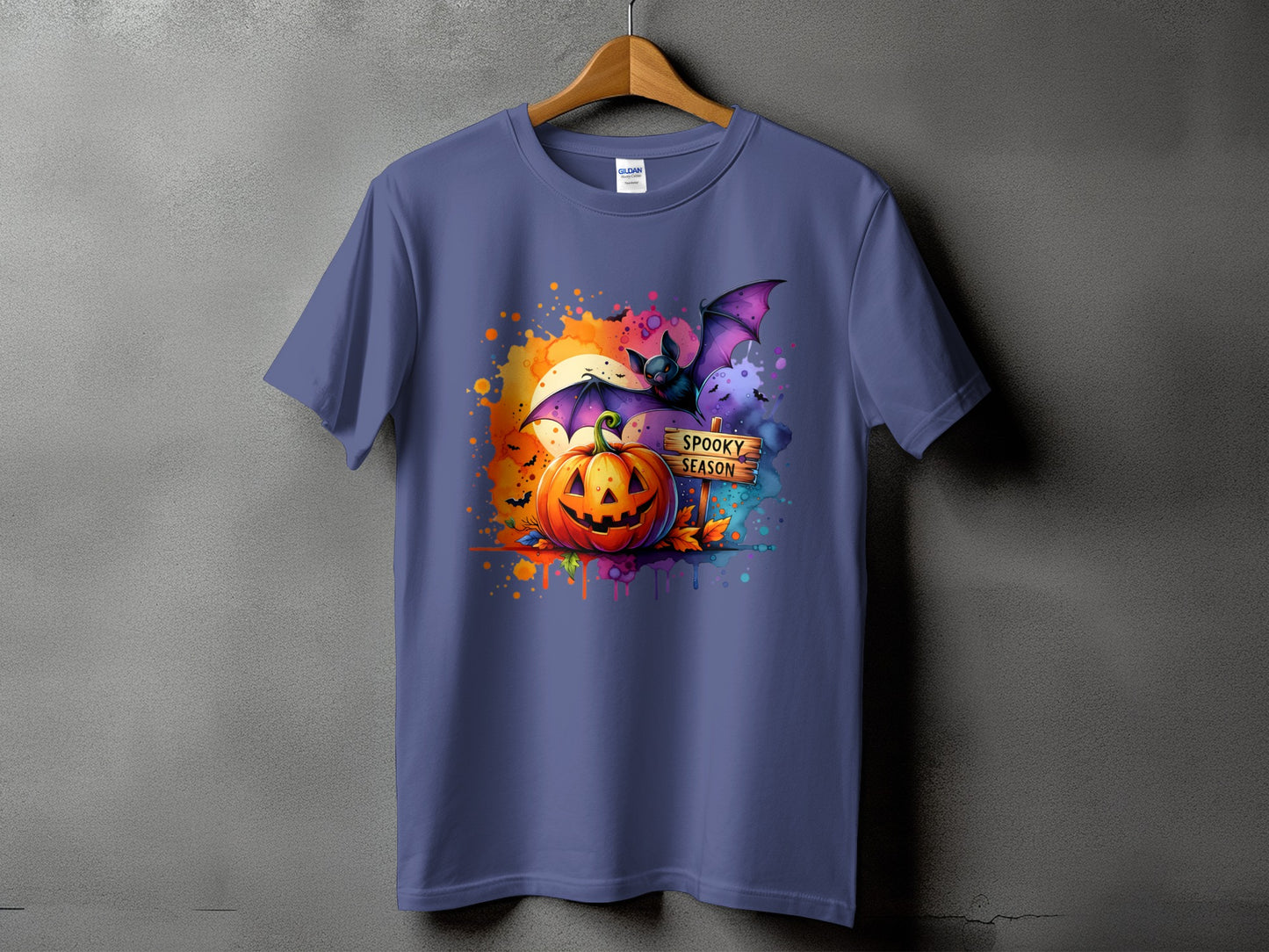 Purple t-shirt with Halloween graphic of pumpkin, bat, and "Spooky Season" sign.