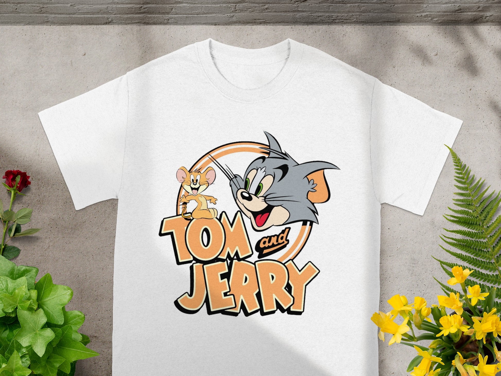 White t-shirt featuring Tom and Jerry cartoon characters and logo.