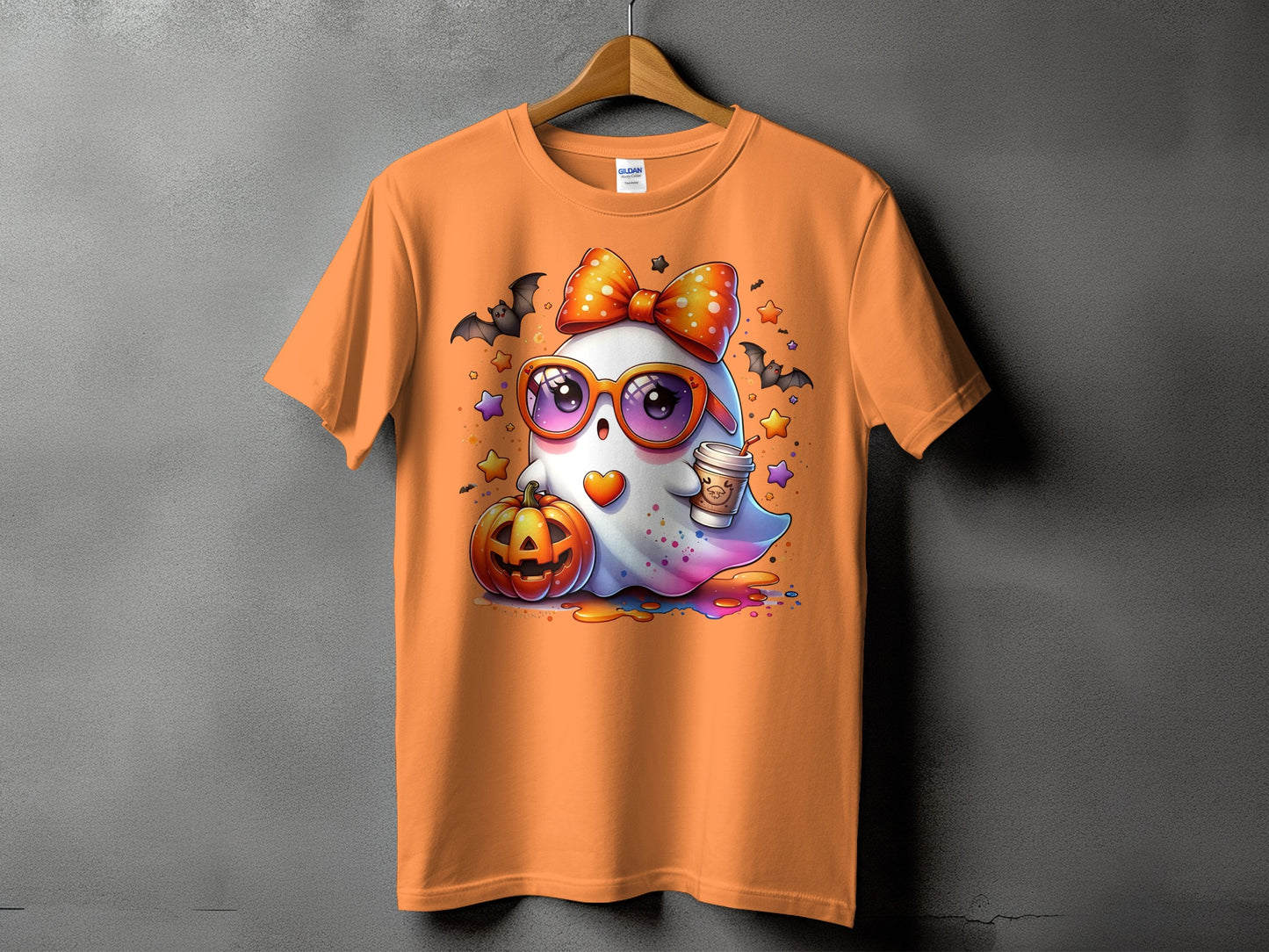 Orange t-shirt with a cartoon ghost, pumpkin, bats, and a coffee cup.