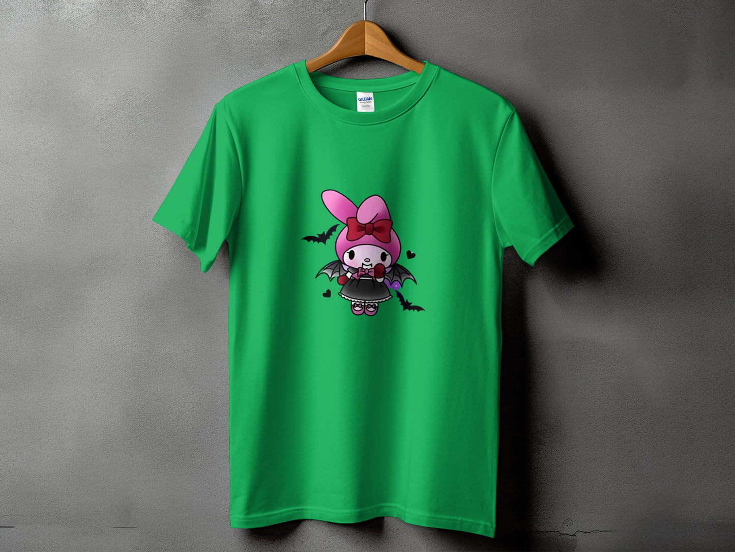 Green t-shirt with cartoon vampire bunny wearing a bow and holding balloons.