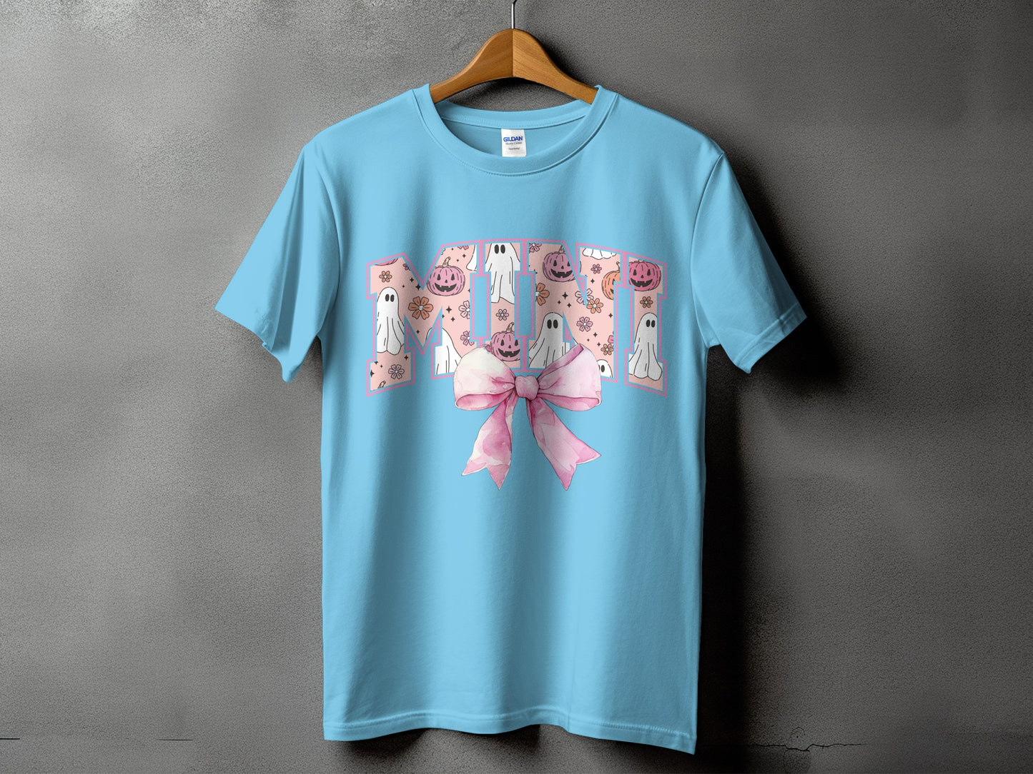 Light blue t-shirt with "Mimi" text featuring ghosts, pumpkins, flowers, and a pink bow.