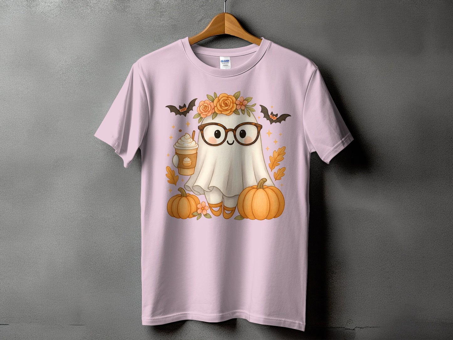 Cute ghost graphic on a light pink t-shirt with pumpkins, bats, and coffee cup.