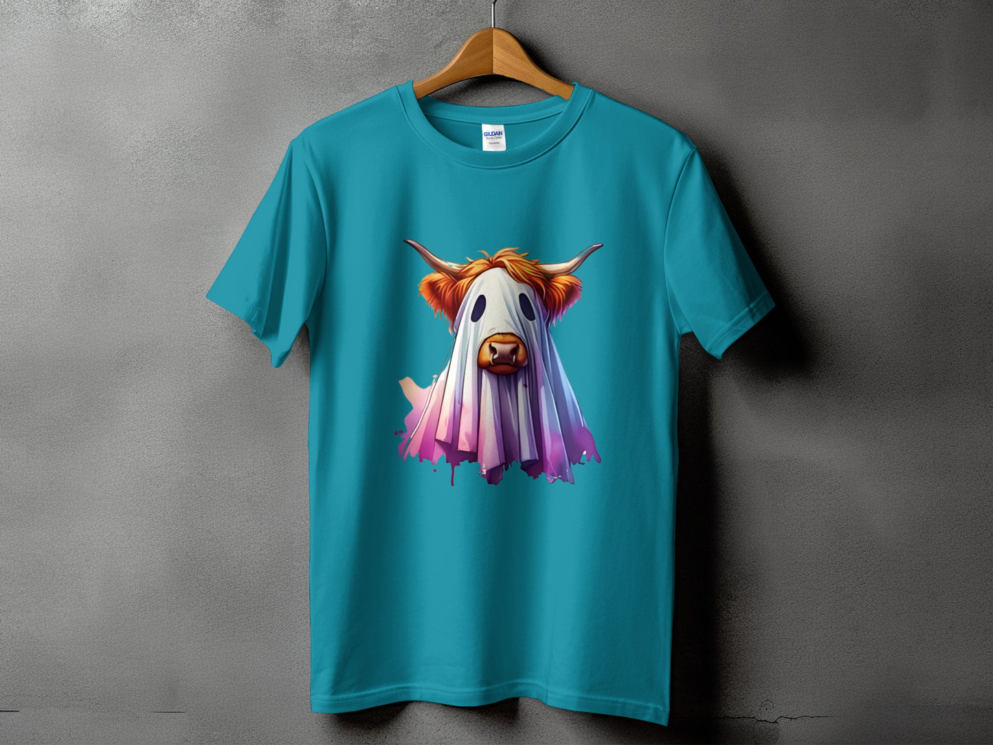 Teal t-shirt with a highland cow dressed as a ghost graphic.