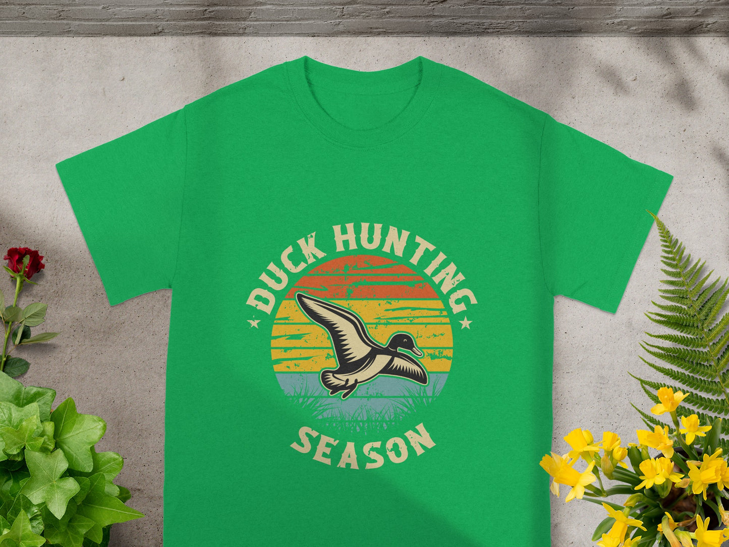 Green t-shirt with a sunset and duck graphic that reads "Duck Hunting Season".