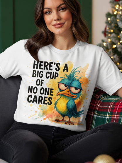 White t-shirt with a blue bird graphic and text "HERE'S A BIG CUP OF NO ONE CARES".