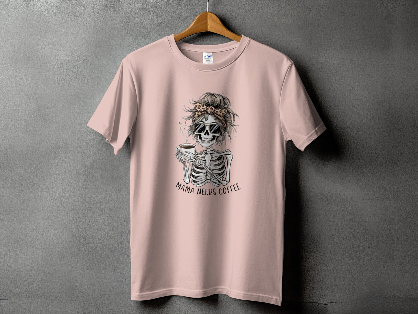 Skeleton with sunglasses and messy bun holding coffee cup, text "Mama Needs Coffee".