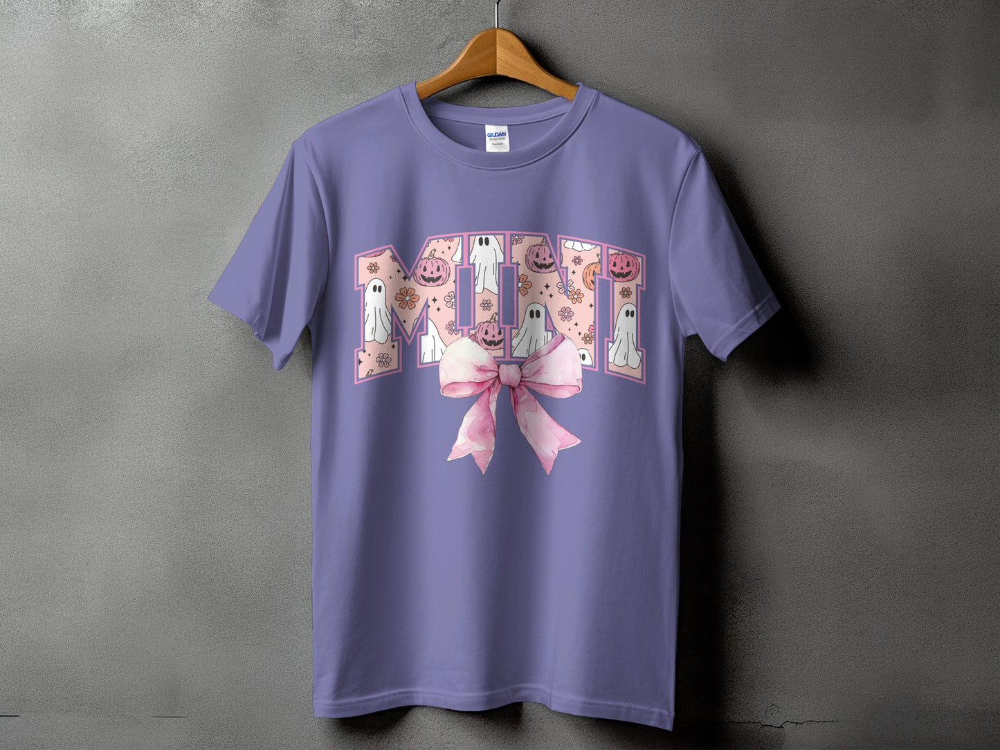 Purple t-shirt with "MIMI" in a pink Halloween-themed design and a pink bow.
