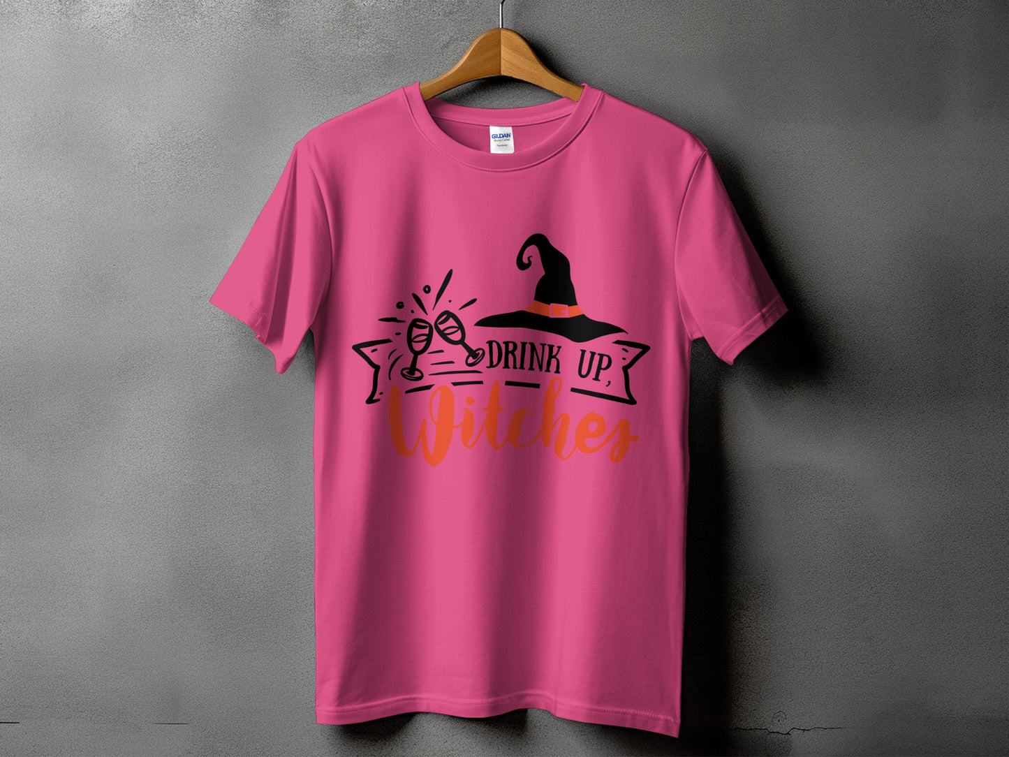 Pink t-shirt with "Drink Up, Witches" text and witch hat graphic.