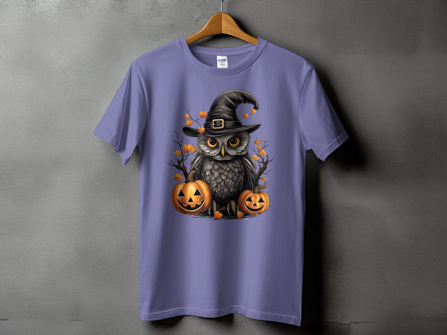 Purple t-shirt featuring a Halloween owl graphic with pumpkins and autumn leaves.