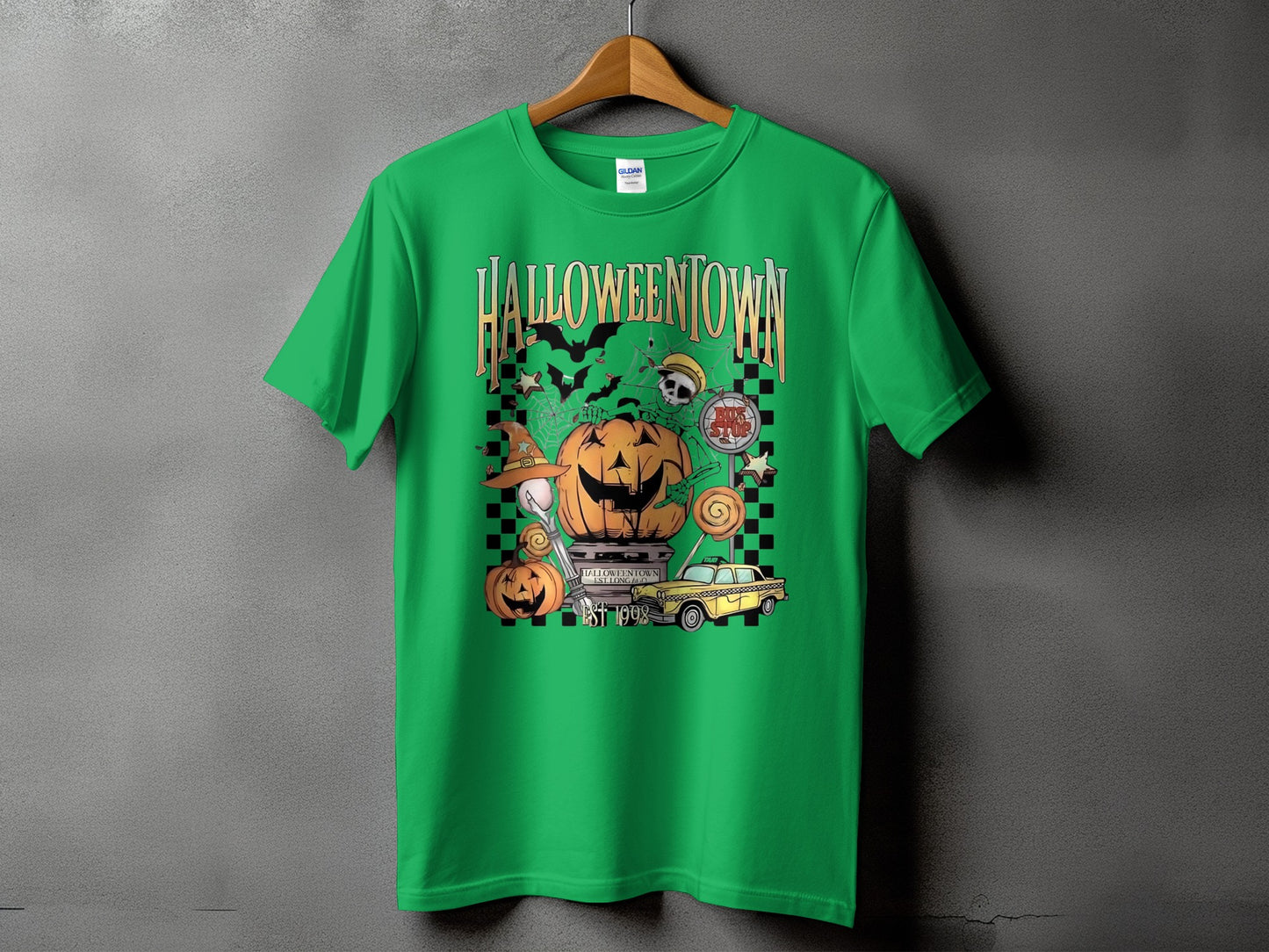 Green t-shirt with Halloweentown graphic featuring jack-o'-lanterns, bats, and a yellow taxi.