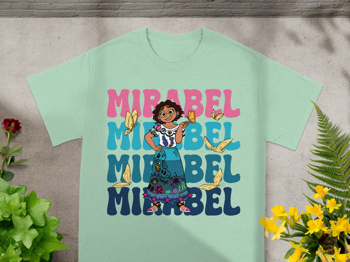 Mirabel from Encanto graphic t-shirt with butterfly and floral accents.
