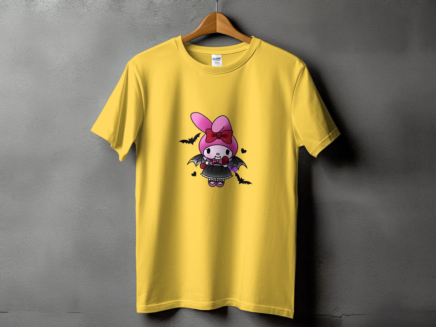 Yellow t-shirt with a cartoon bat character with pink bow and wings.