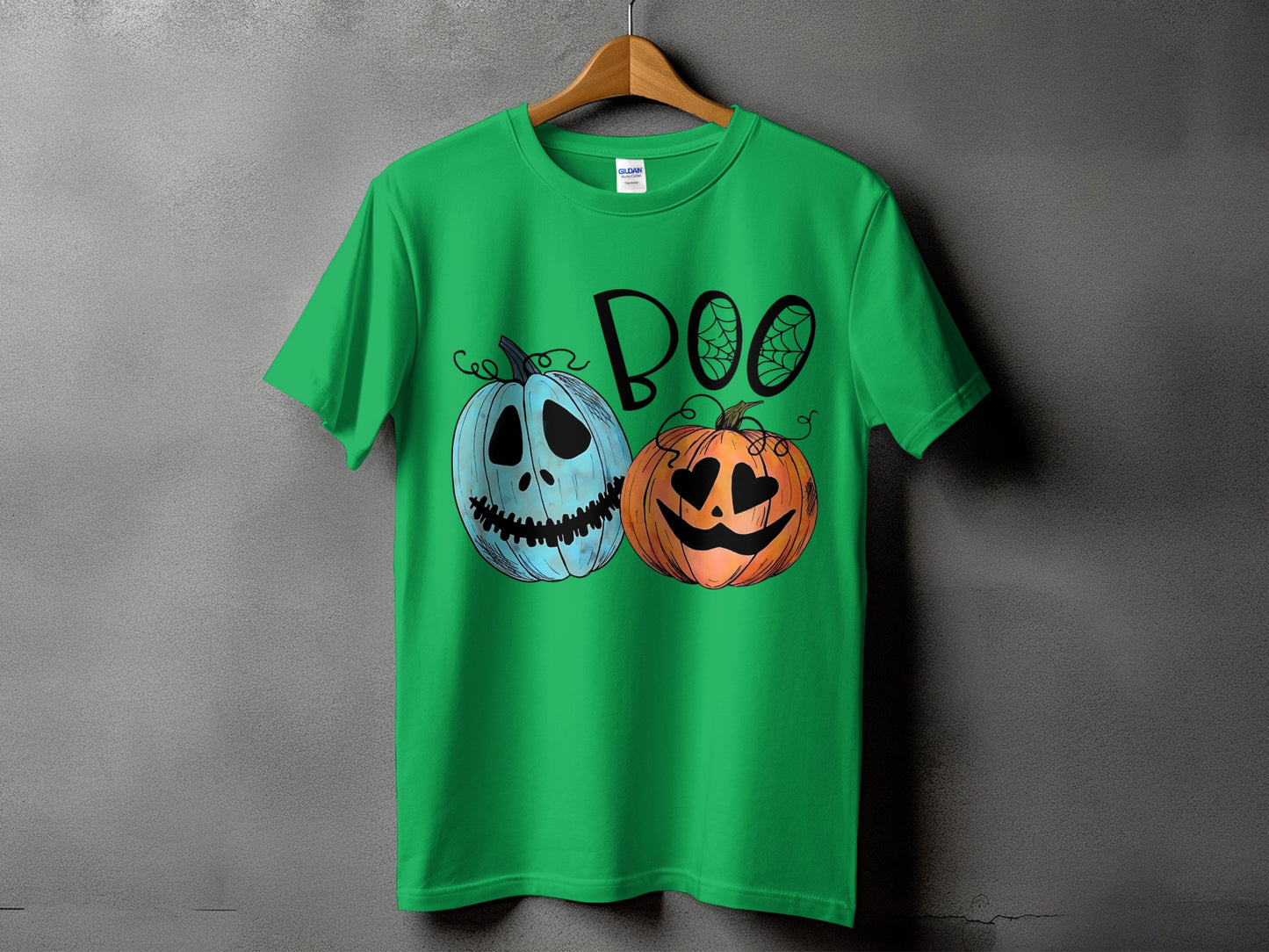 Green t-shirt with "Boo" text and cartoon pumpkins with Halloween faces.