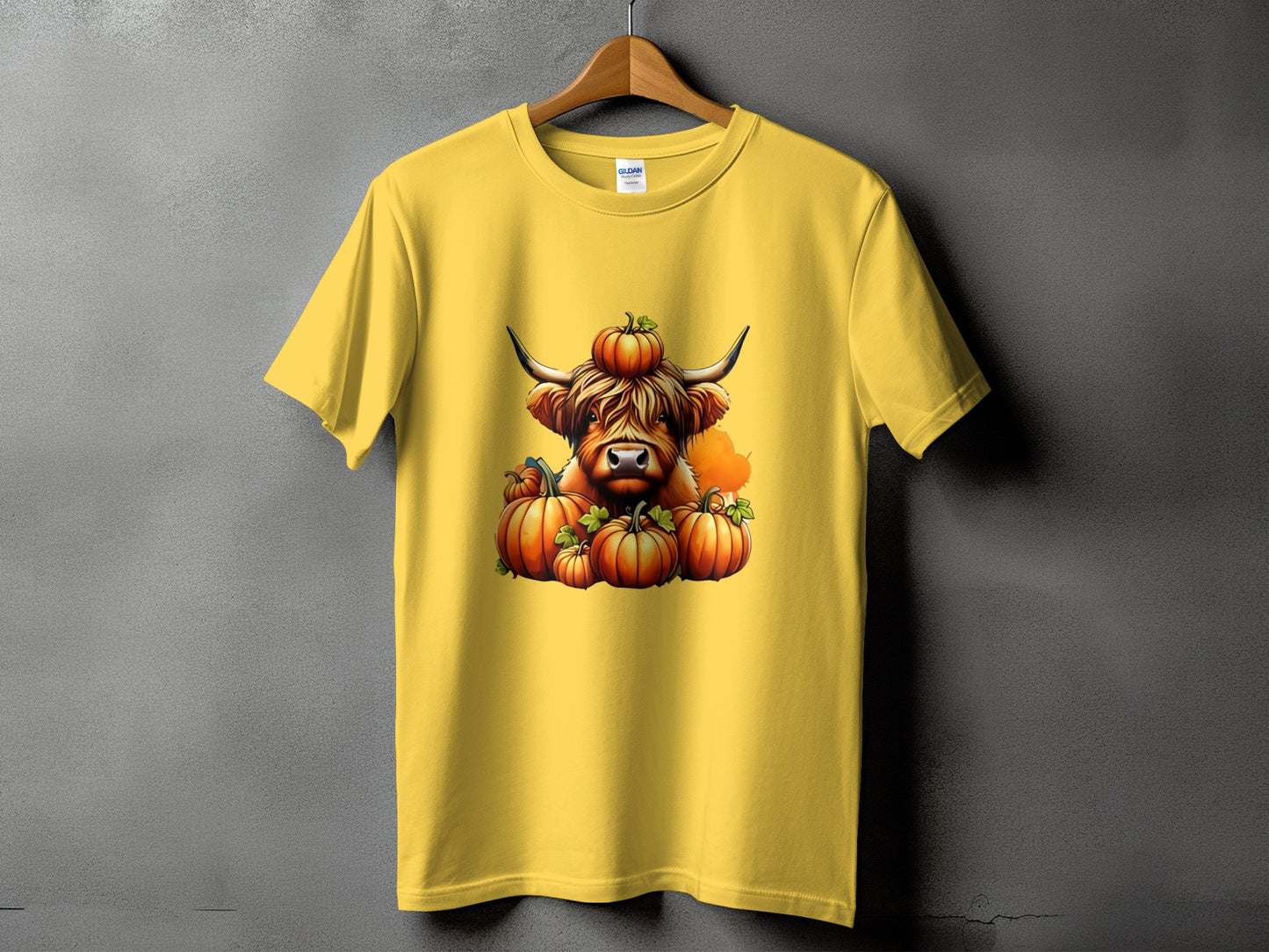 Yellow t-shirt with a highland cow and pumpkins graphic.