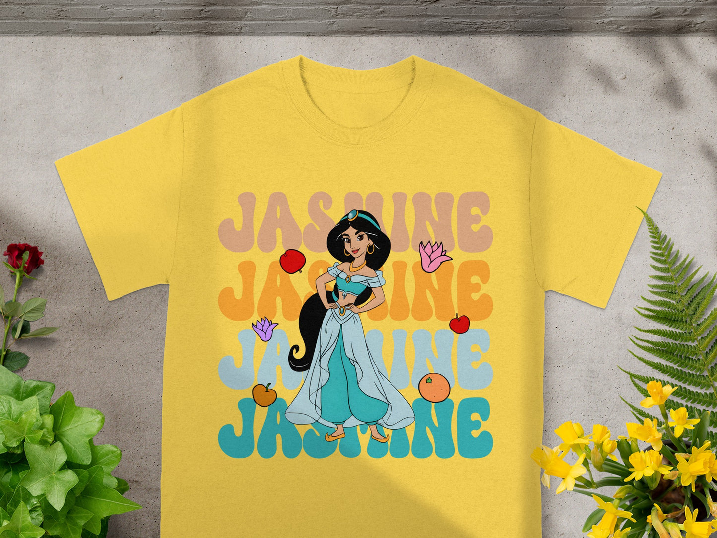 Disney Princess Jasmine on a yellow t-shirt with colorful text.