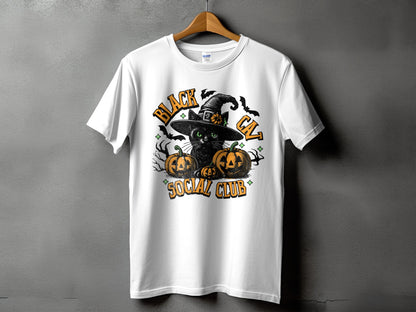 White t-shirt with a black cat wearing a witch hat and pumpkins, text reads "Black Cat Social Club".