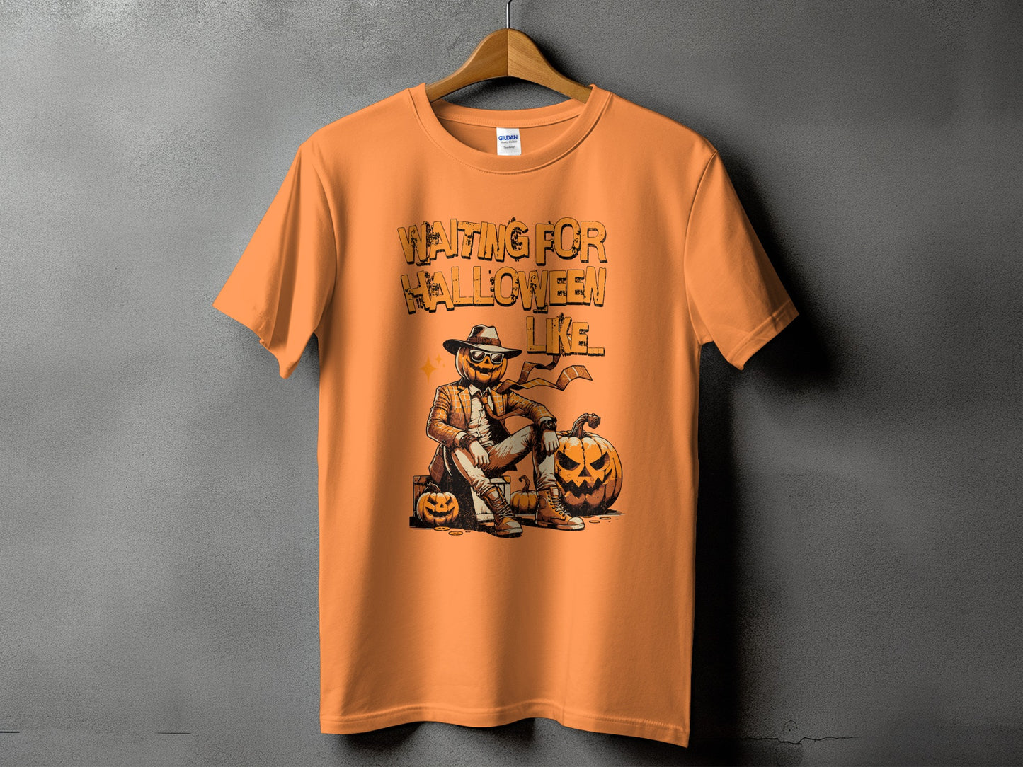 Orange t-shirt with "Waiting for Halloween" graphic featuring a scarecrow pumpkin.