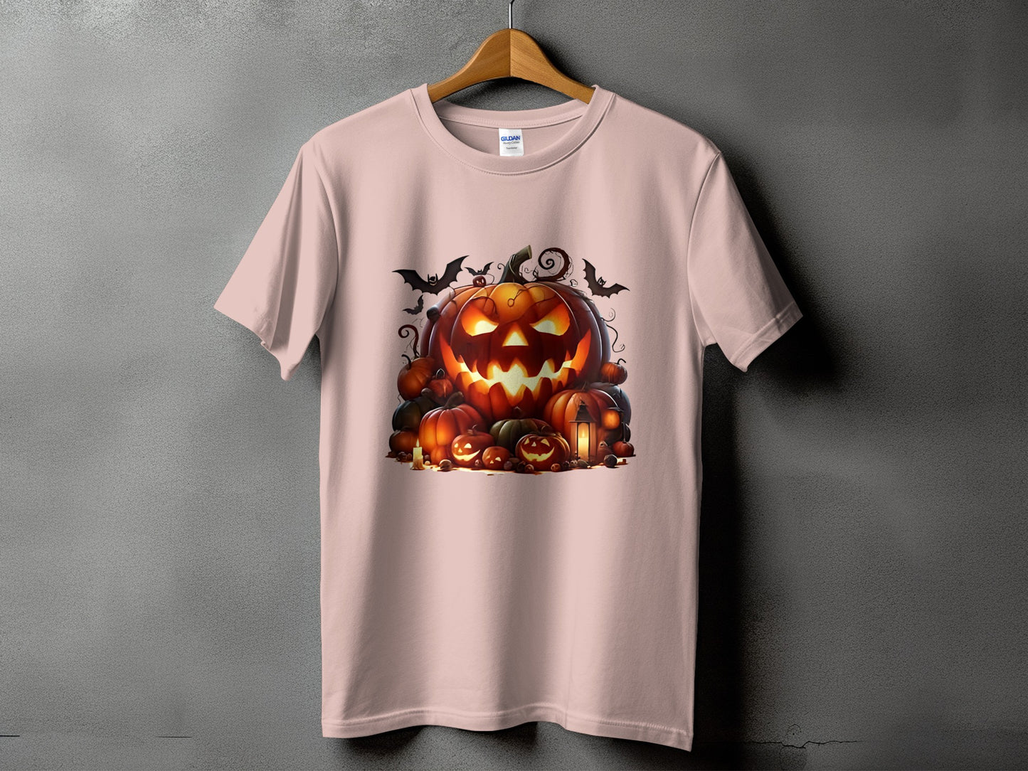 Pink t-shirt with a Halloween pumpkin graphic and bats.