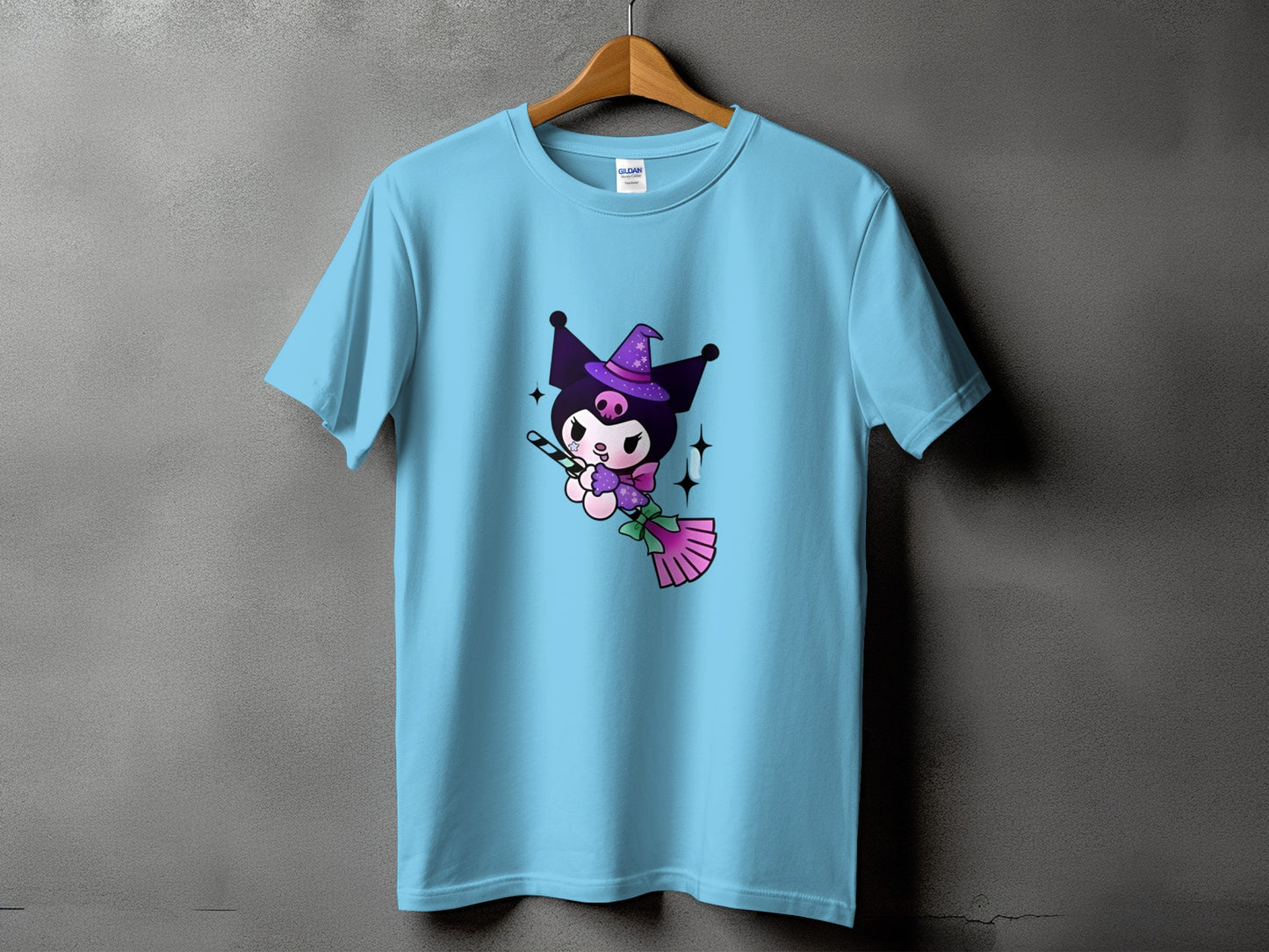 Light blue t-shirt with Kuromi flying on a broomstick wearing a witch hat.