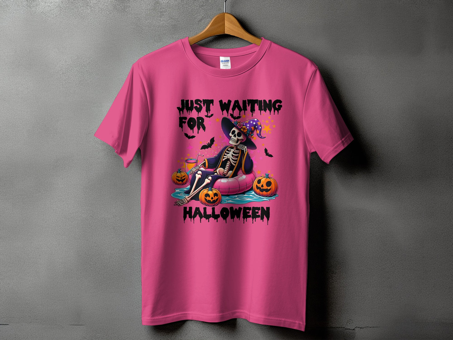 Pink t-shirt with skeleton graphic saying "Just Waiting for Halloween."