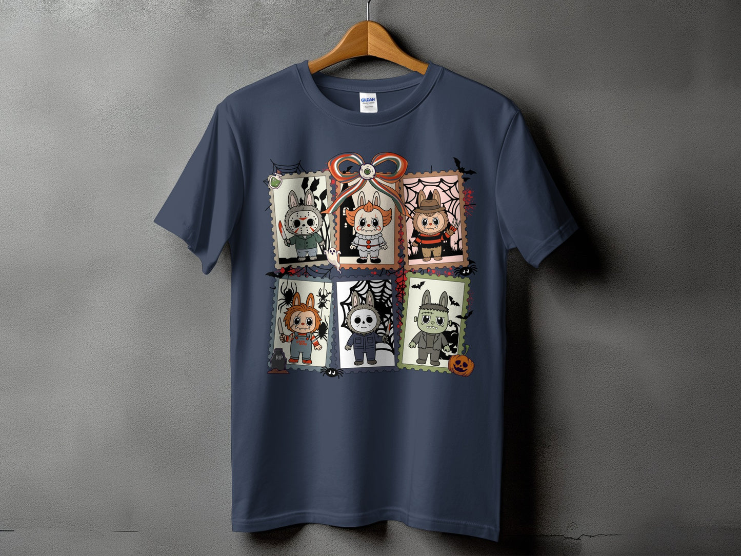 Dark blue t-shirt with six Halloween characters in stamp frames and a central bow.
