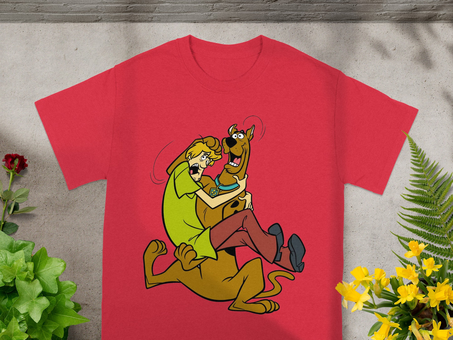 Scooby-Doo and Shaggy hug on a red t-shirt design.