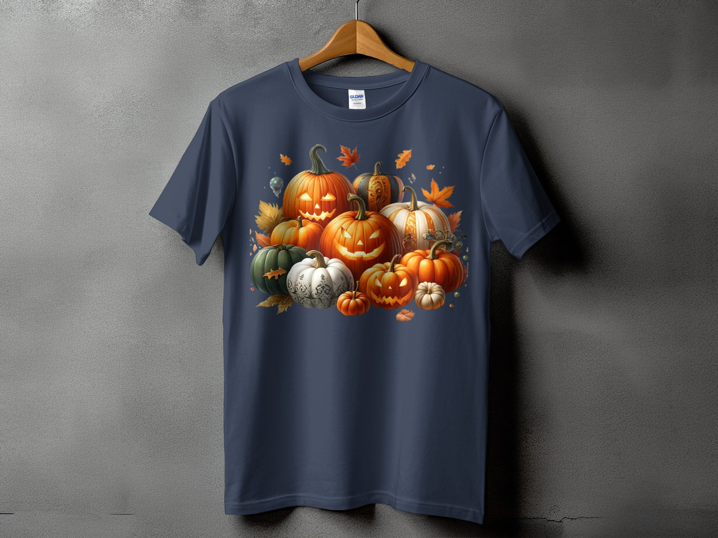 T-shirt with a graphic of various carved and decorative pumpkins with autumn leaves.