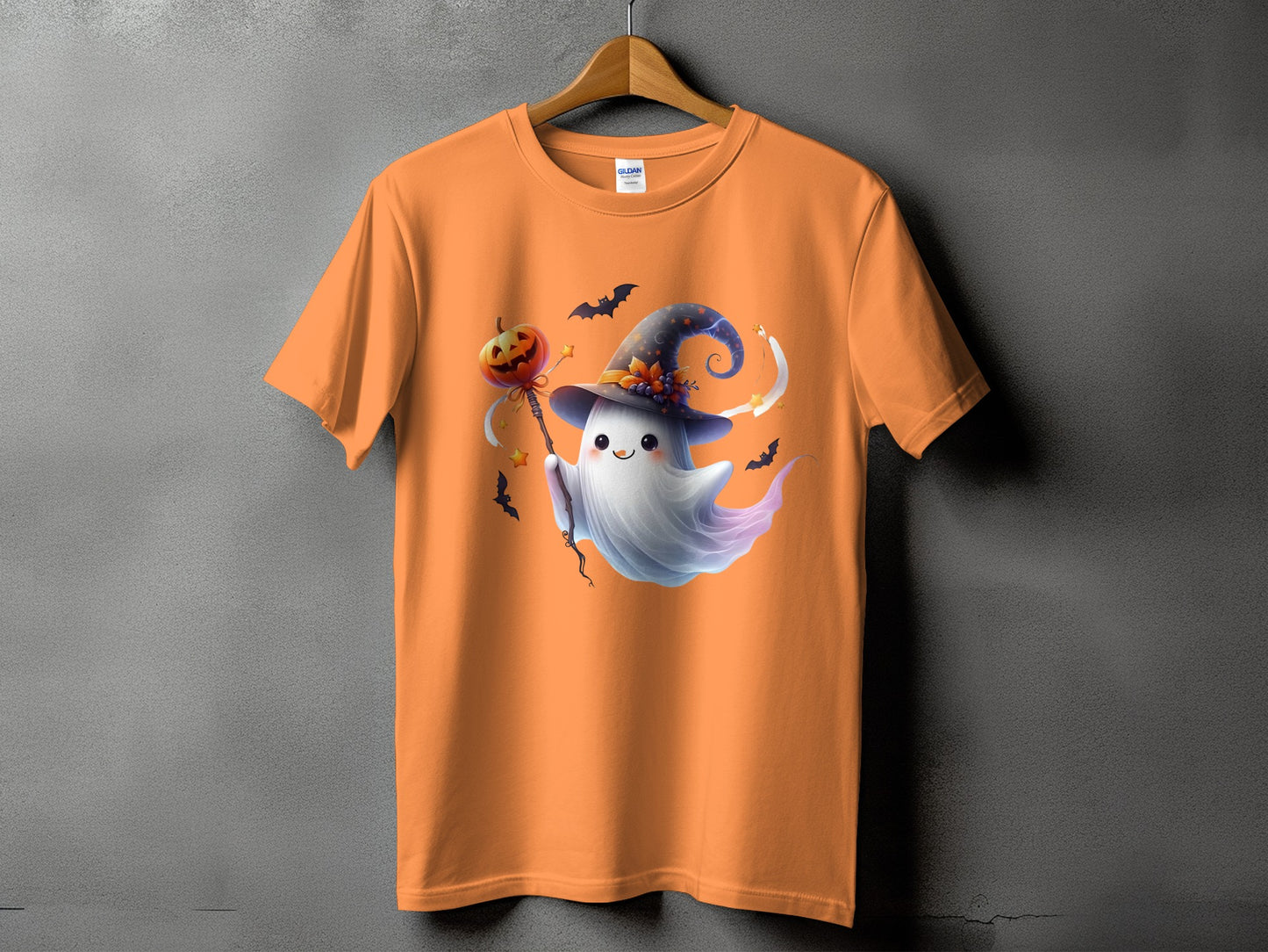 Orange t-shirt featuring a cute ghost in a witch hat with a pumpkin wand.