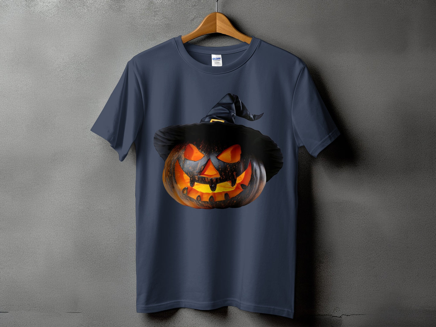 Dark t-shirt with a glowing Jack-o'-lantern wearing a witch hat.