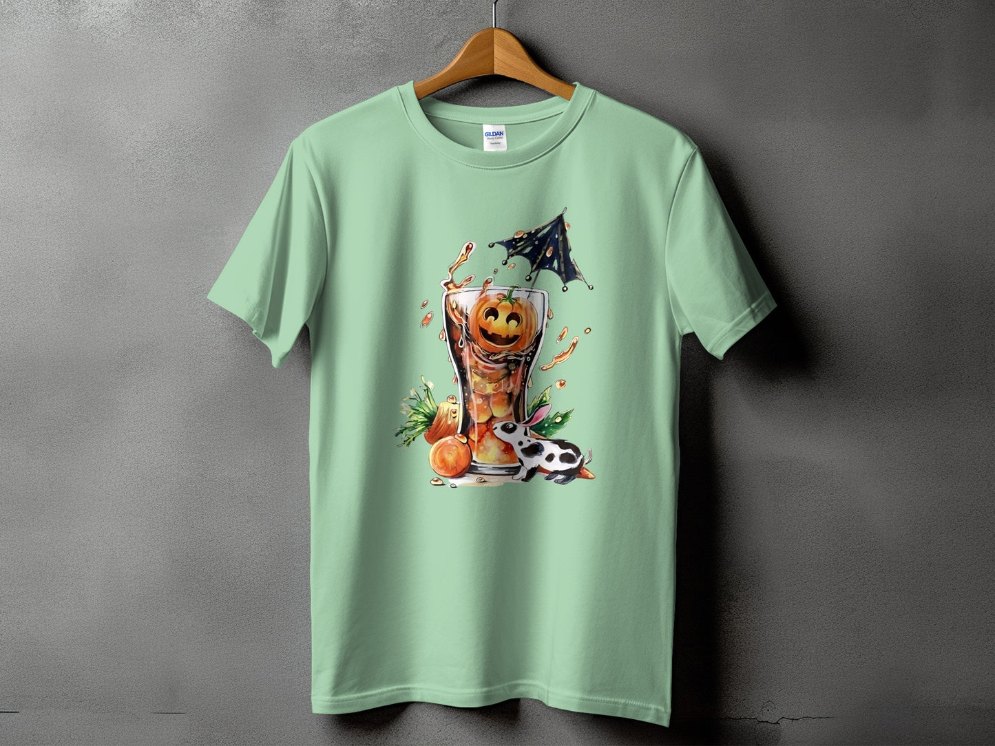 Green t-shirt with a Halloween graphic of a pumpkin in a drink with a rabbit.