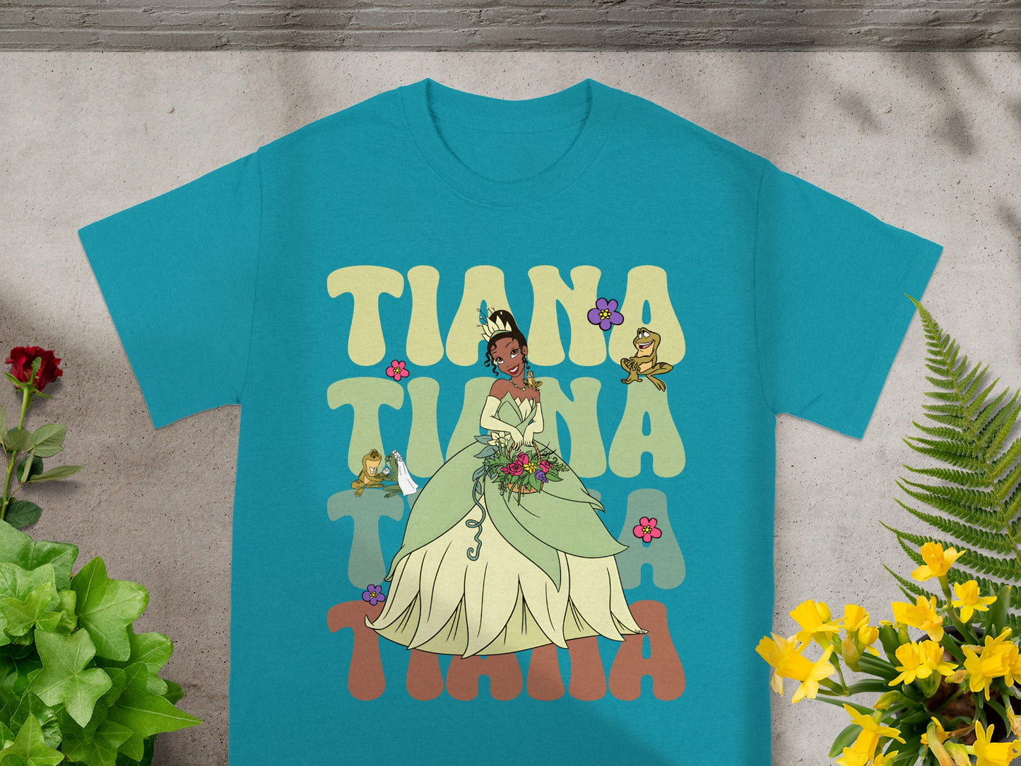 Tiana wearing a green gown with "Tiana" text and flowers.