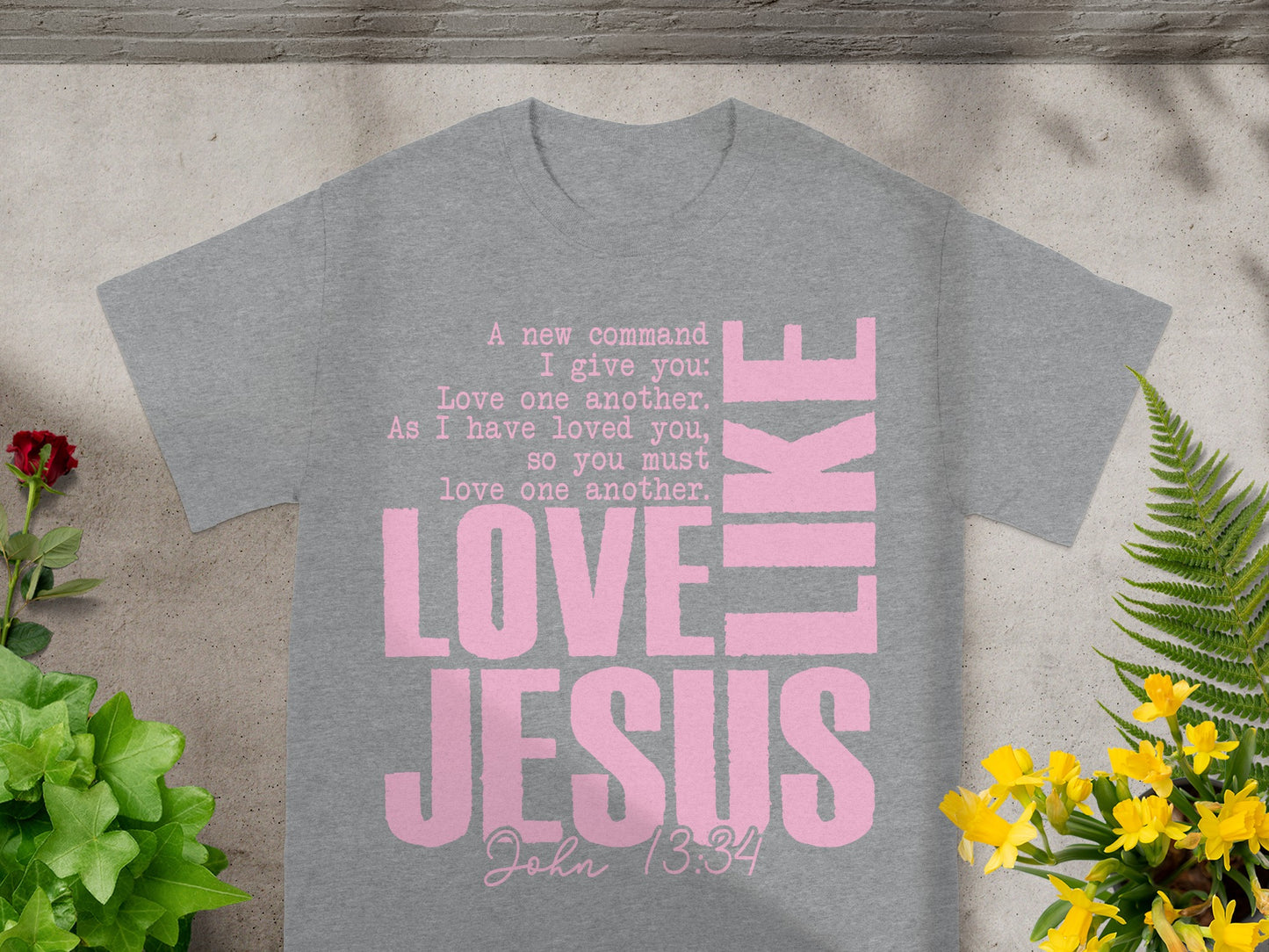 Grey t-shirt with pink text "Love Jesus Like" and Bible verse John 13:34.