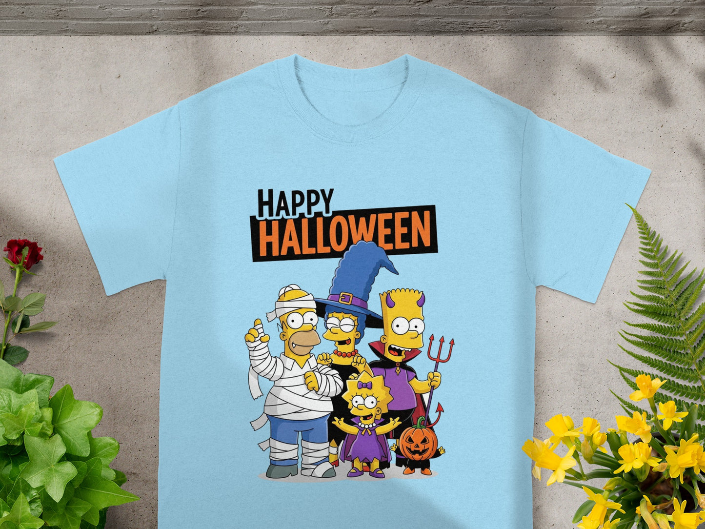 The Simpsons characters in Halloween costumes with "Happy Halloween" text on a light blue shirt.