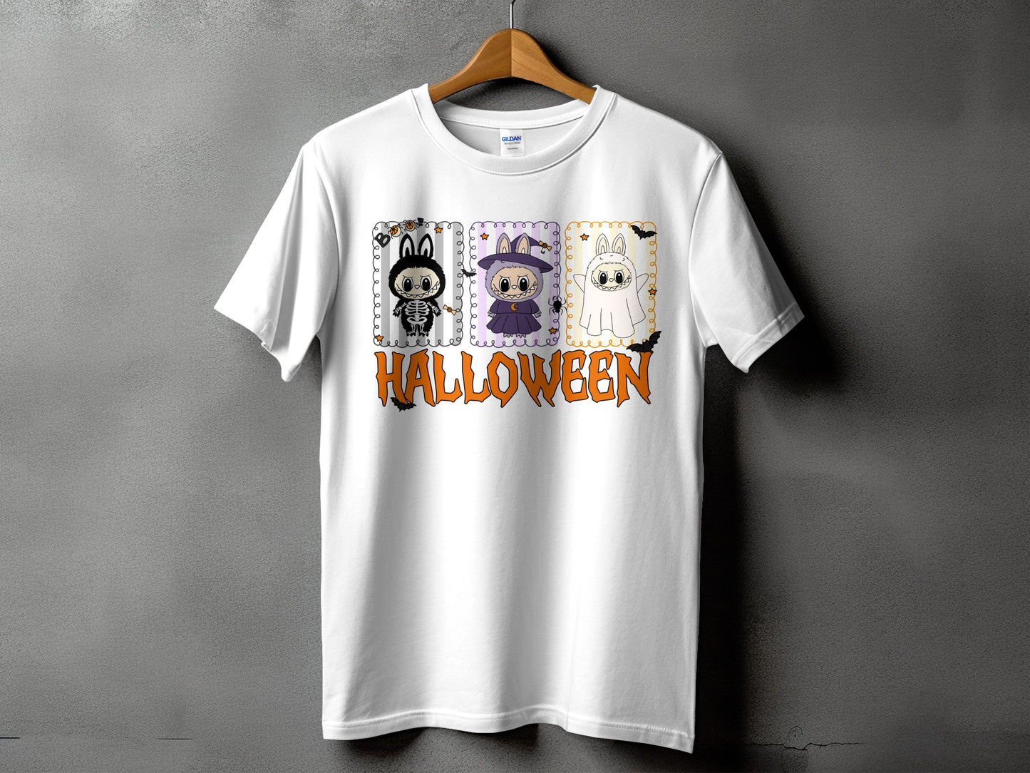 White t-shirt with three Halloween themed character squares and orange "Halloween" text.