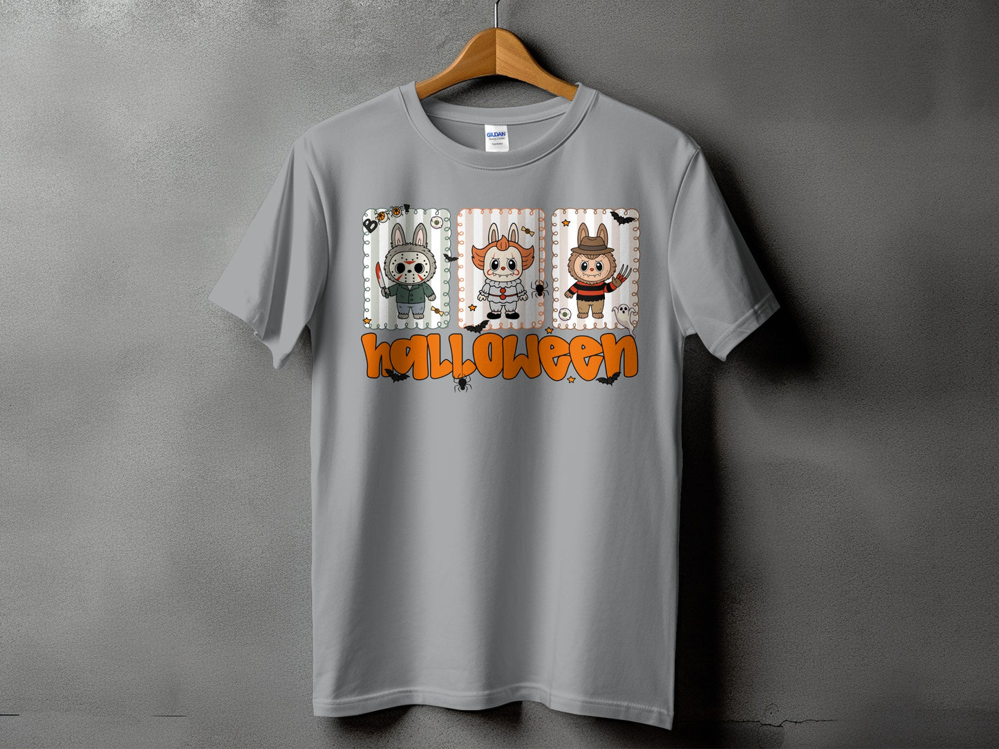 Grey t-shirt with Halloween graphic featuring three cartoon monsters and orange text.