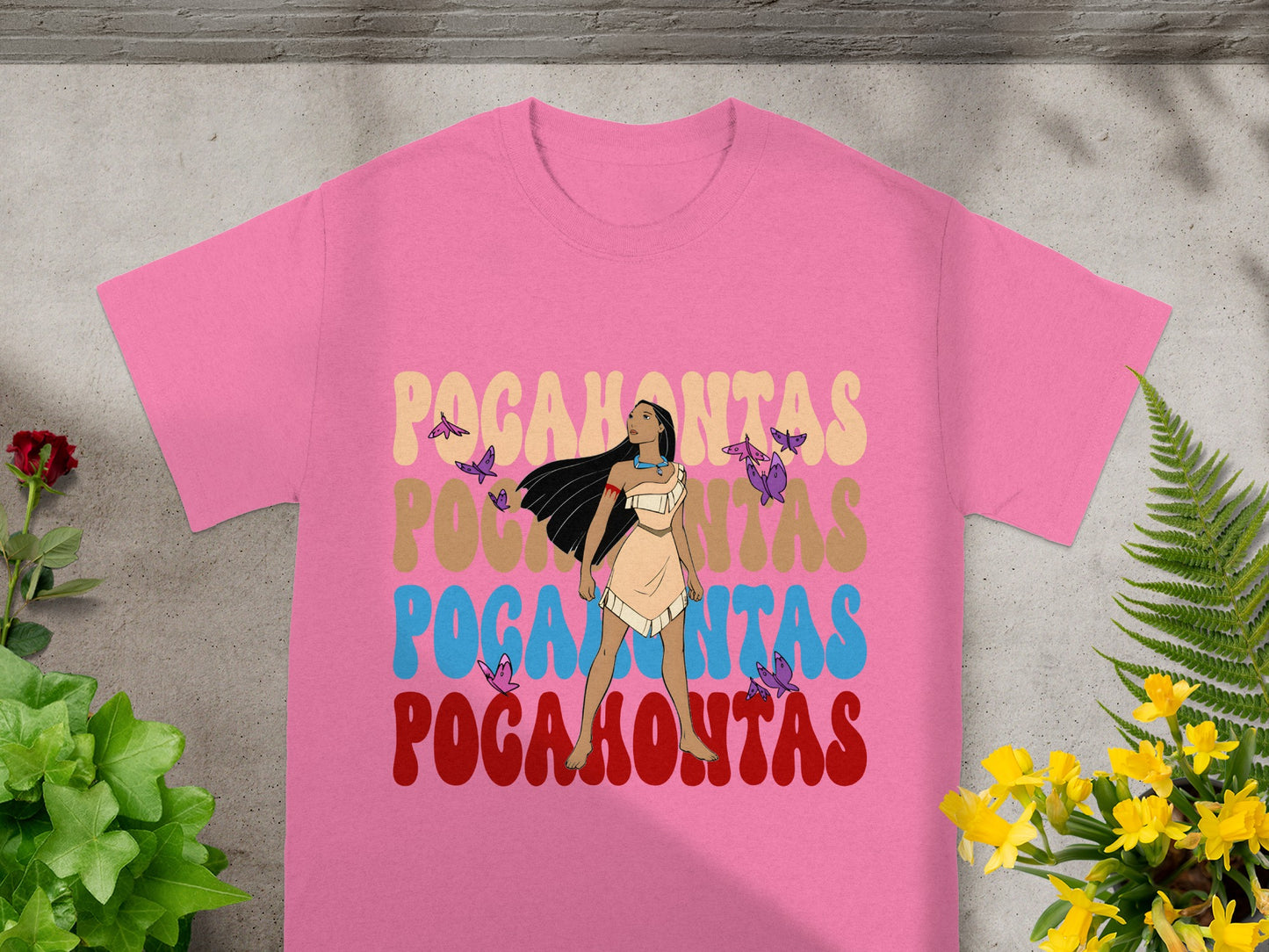 Pink t-shirt with "Pocahontas" in colorful retro font and butterfly accents.