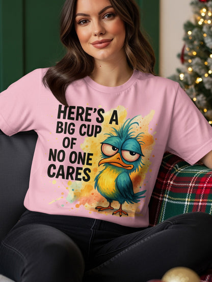 Pink t-shirt with a grumpy blue bird and text "Here's a big cup of no one cares."