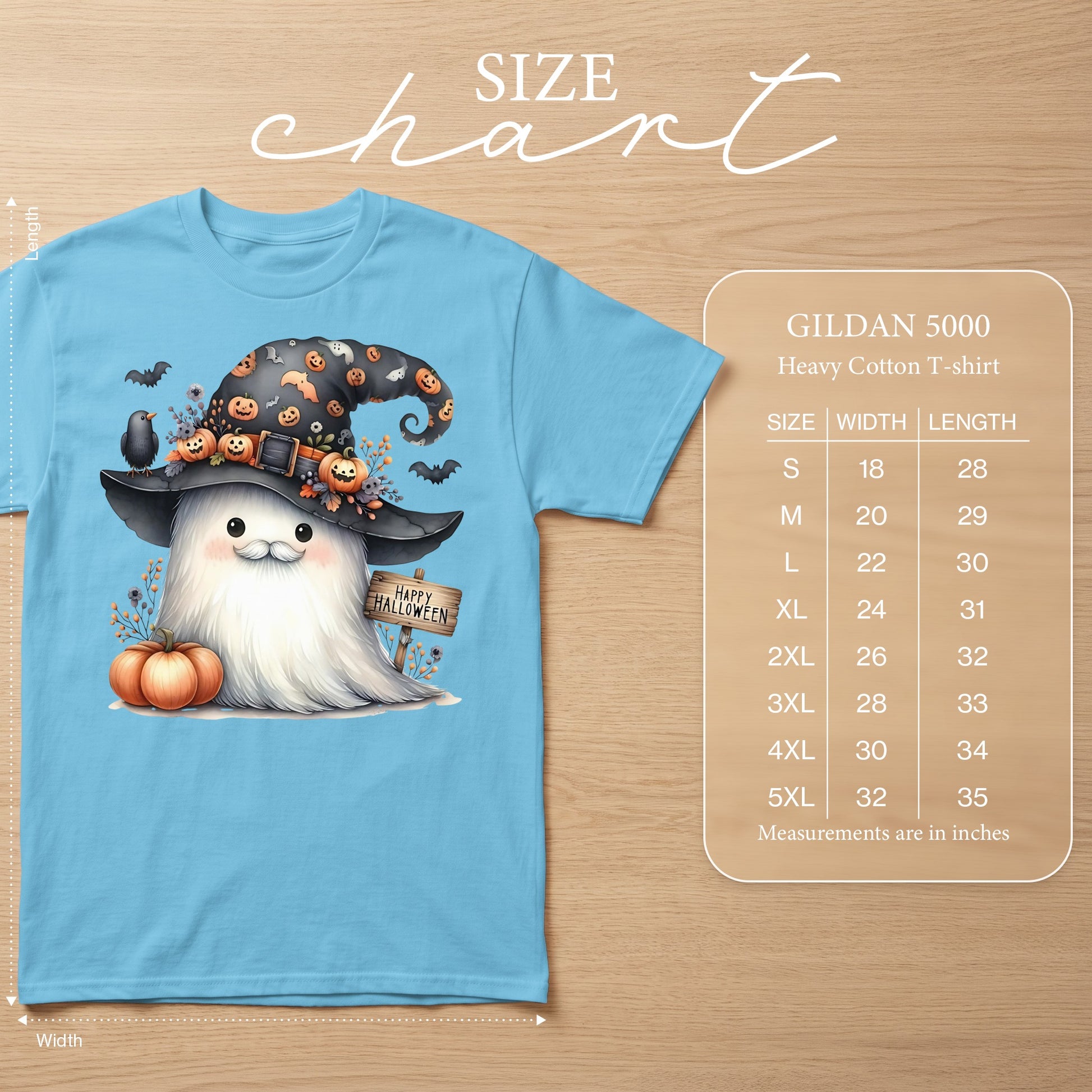 Blue t-shirt with a watercolor ghost wearing a witch hat, holding a pumpkin. Includes size chart.