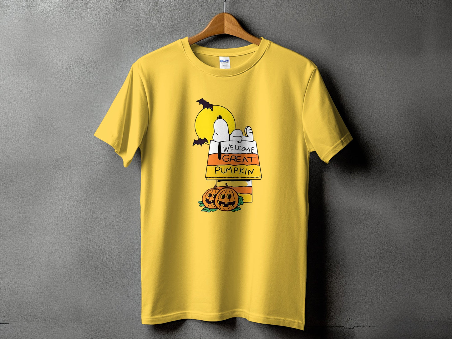 Yellow t-shirt with Snoopy lying in a candy corn pumpkin patch, "Welcome Great Pumpkin" text.