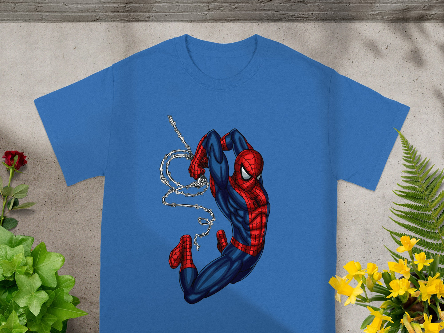 Blue t-shirt with Spider-Man hanging from a web.