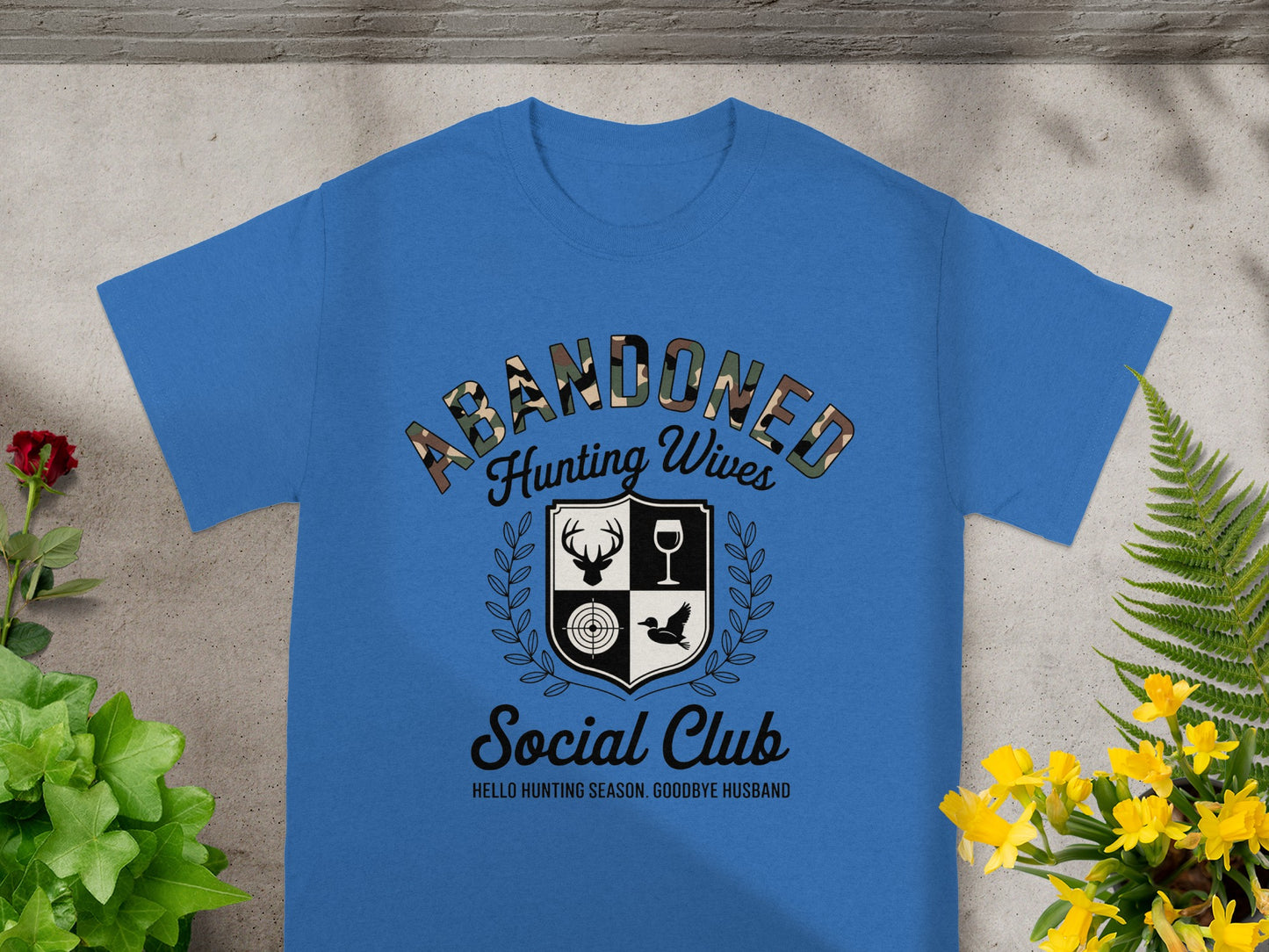 Blue t-shirt with "Abandoned Hunting Wives Social Club" text and crest.