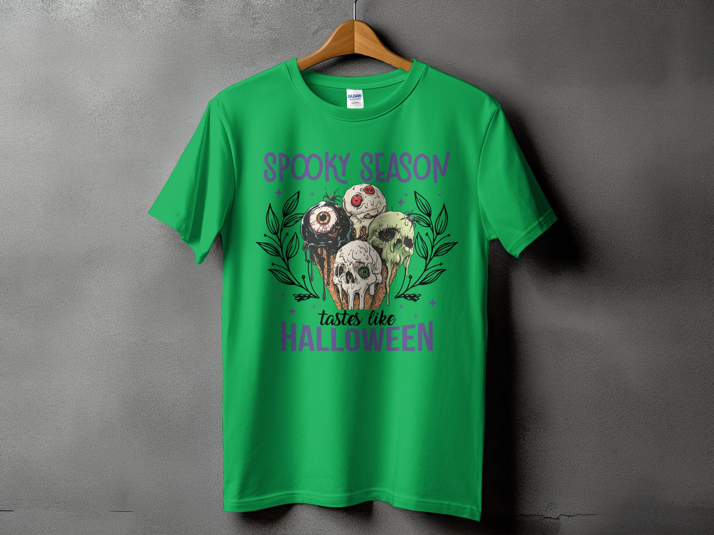 Green t-shirt with "Spooky Season tastes like Halloween" and scary ice cream cones.