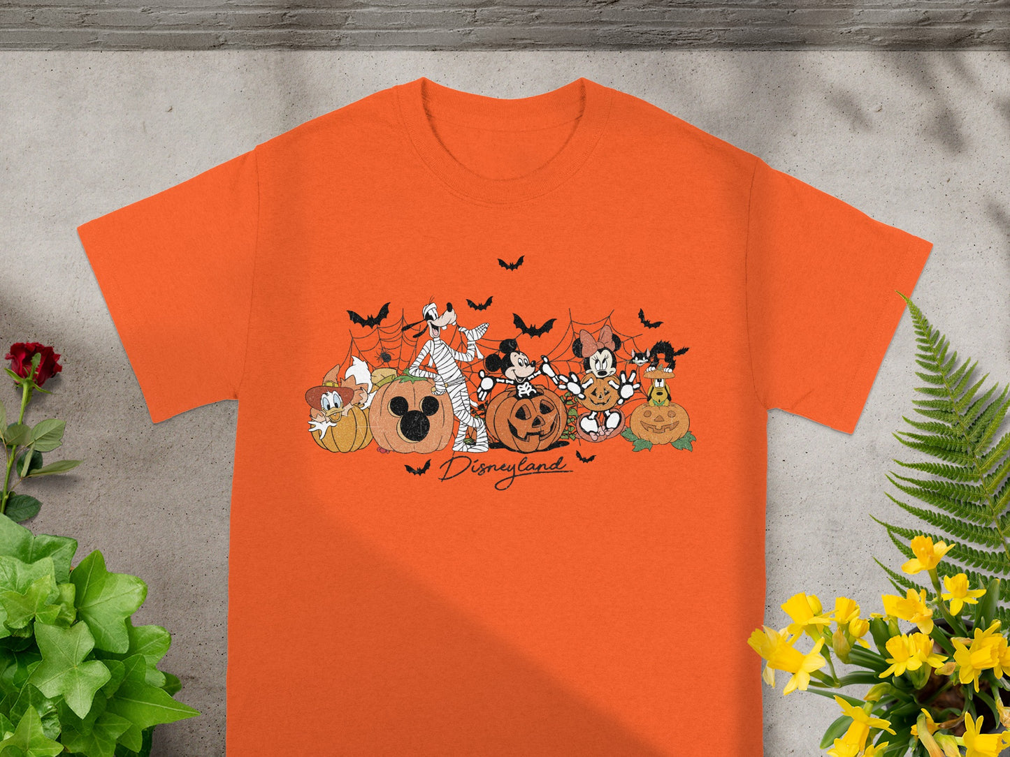 Orange t-shirt with Disneyland Halloween graphic of characters and pumpkins.