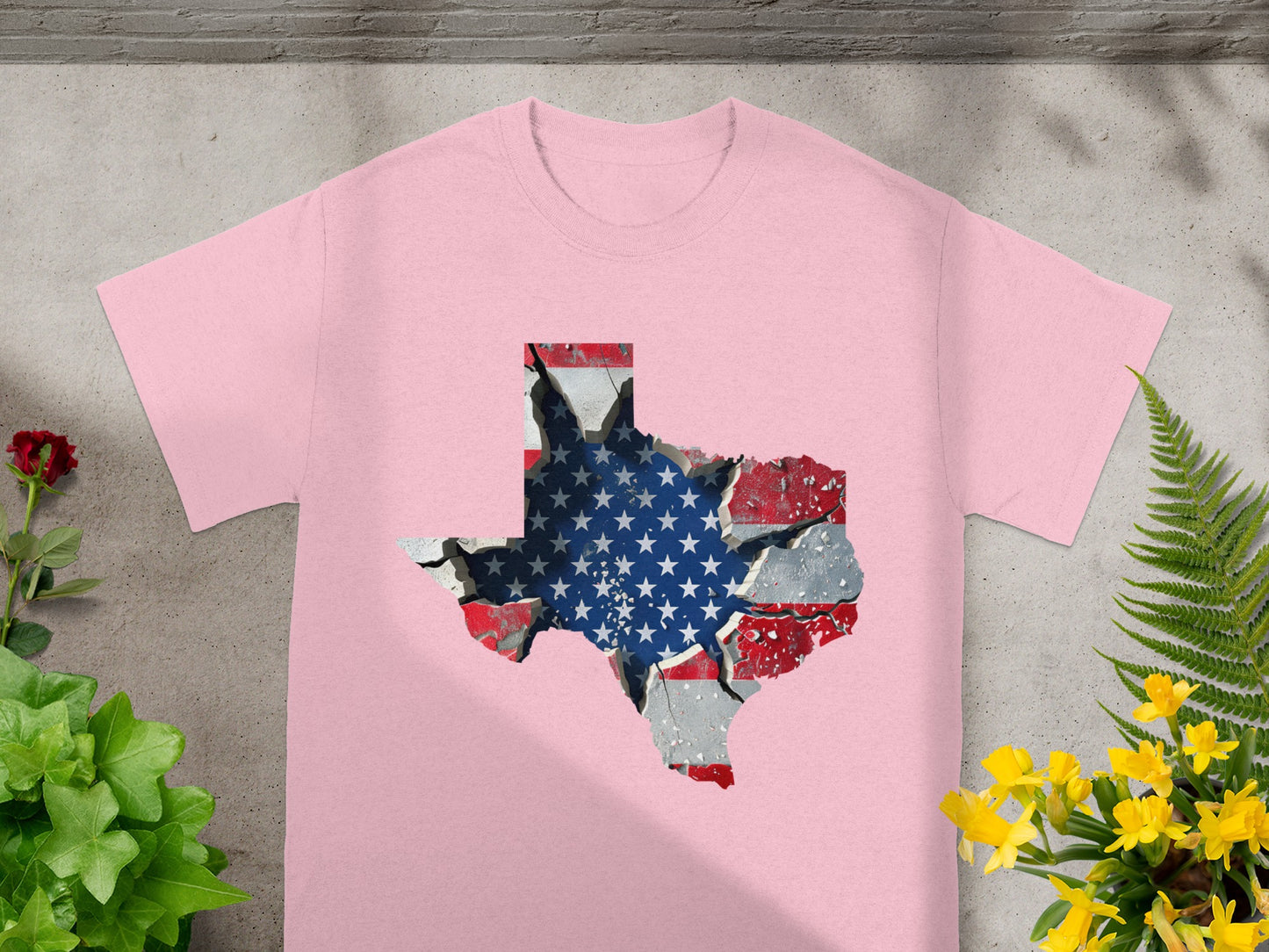 Pink t-shirt with a cracked Texas outline filled with the American flag design.
