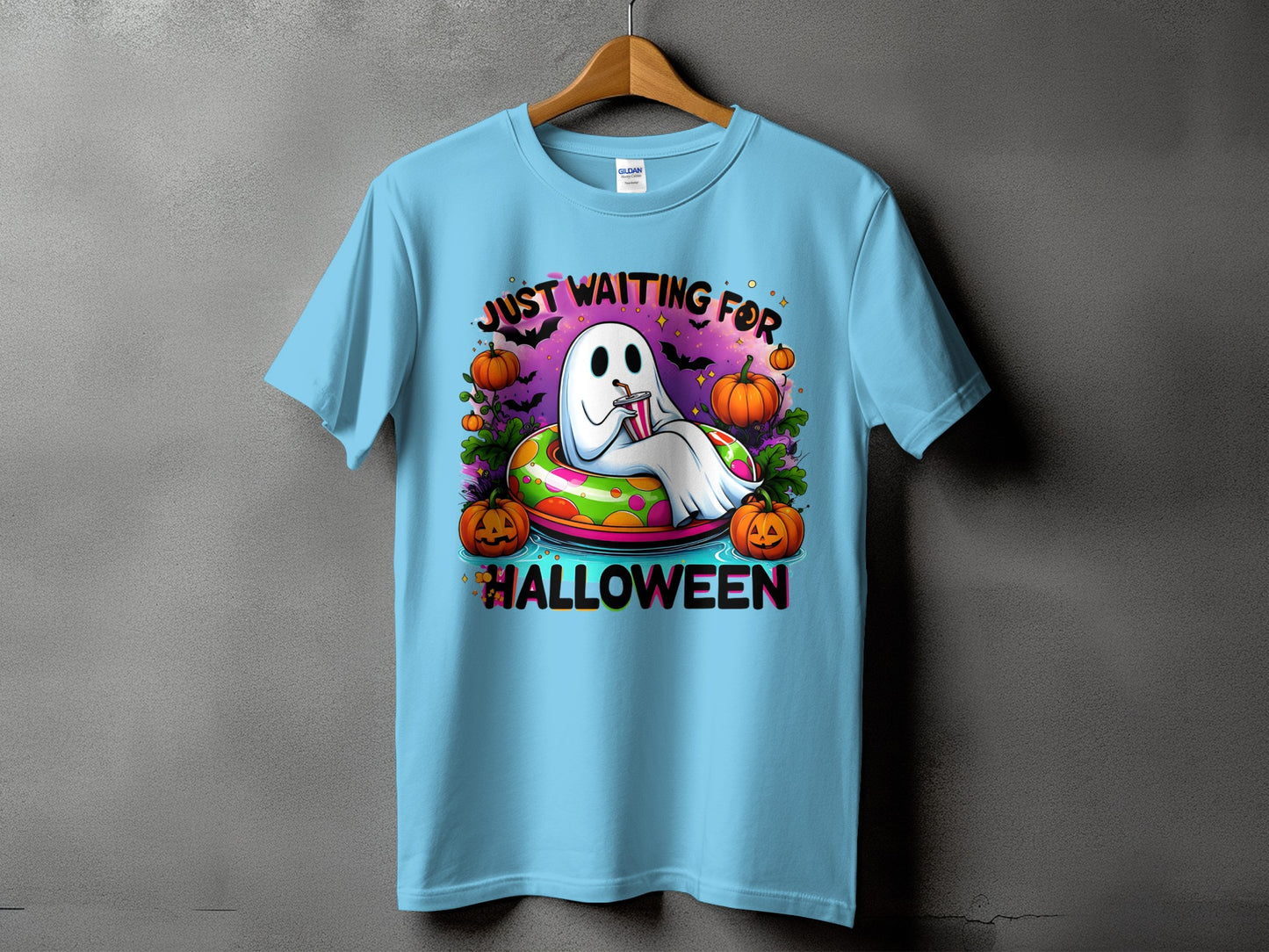 Light blue t-shirt with a ghost in an inflatable tube, pumpkins, and "Halloween" text.