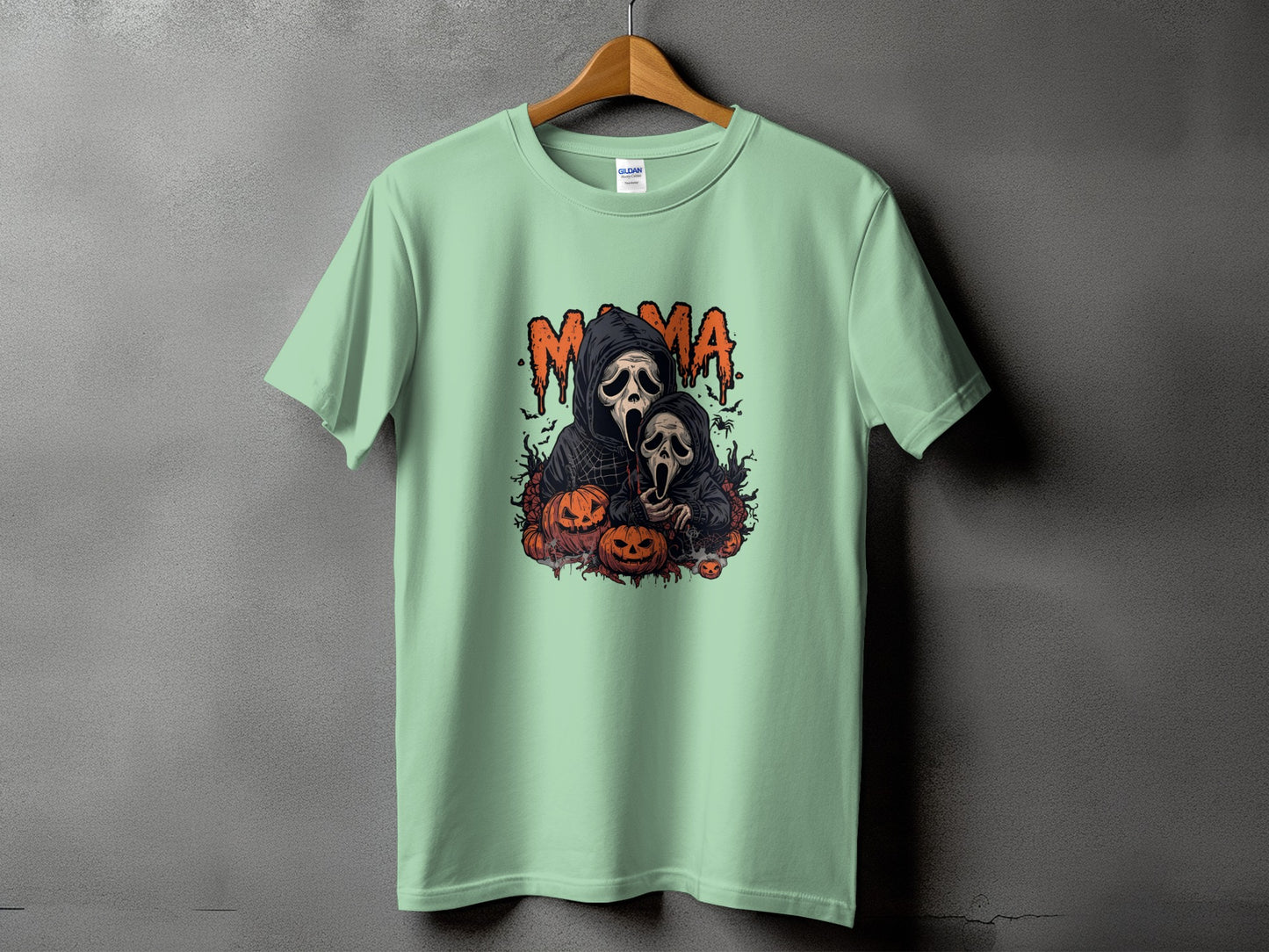 Mint green t-shirt with "Mama" text and spooky ghost and pumpkin graphic.